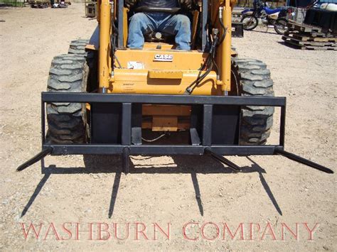 show skid steer with large bale of hay|skid steer round bale spear.